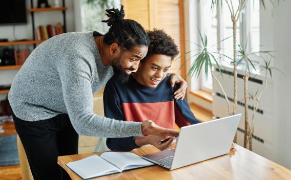 Father and son looking at computer