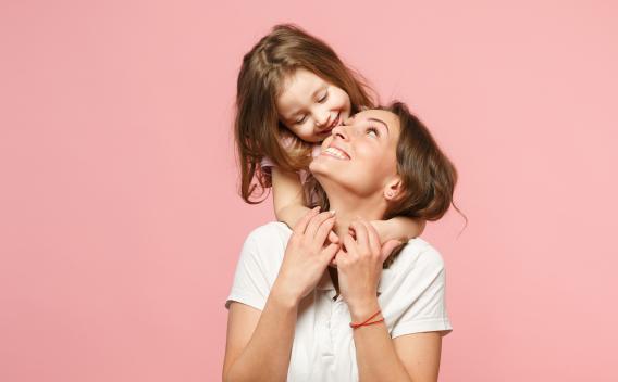Mother looking up to daughter and smiling